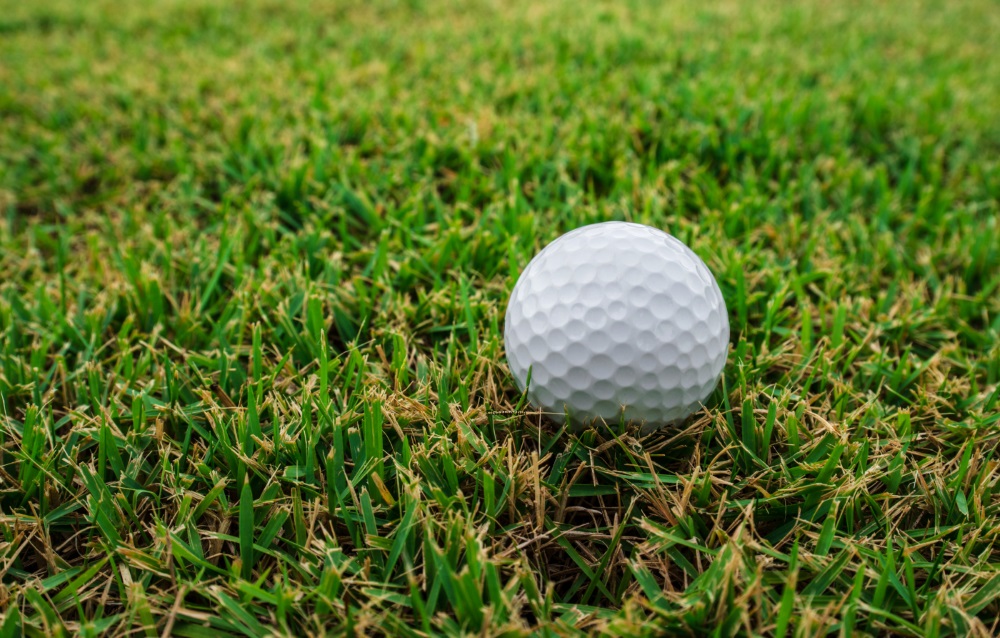 Golf ball on green tee EYEQ Vision Care